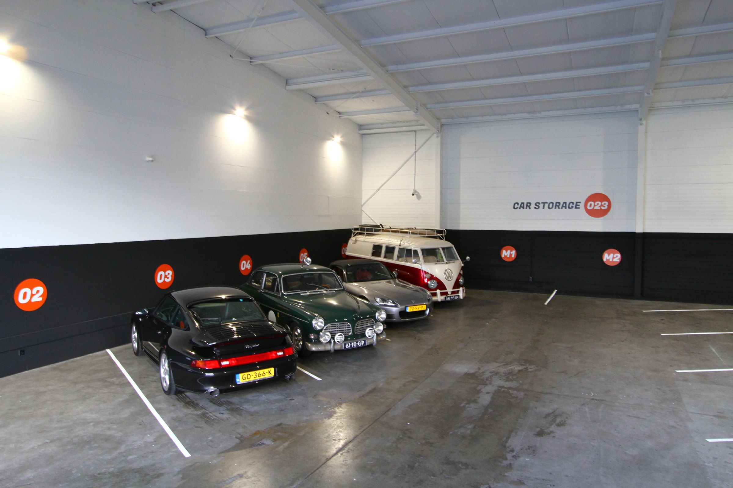 Een Volvo Amazon, een Porsche 911 en een Volkswagen T1-busje in de stalling van Car Storage 023
